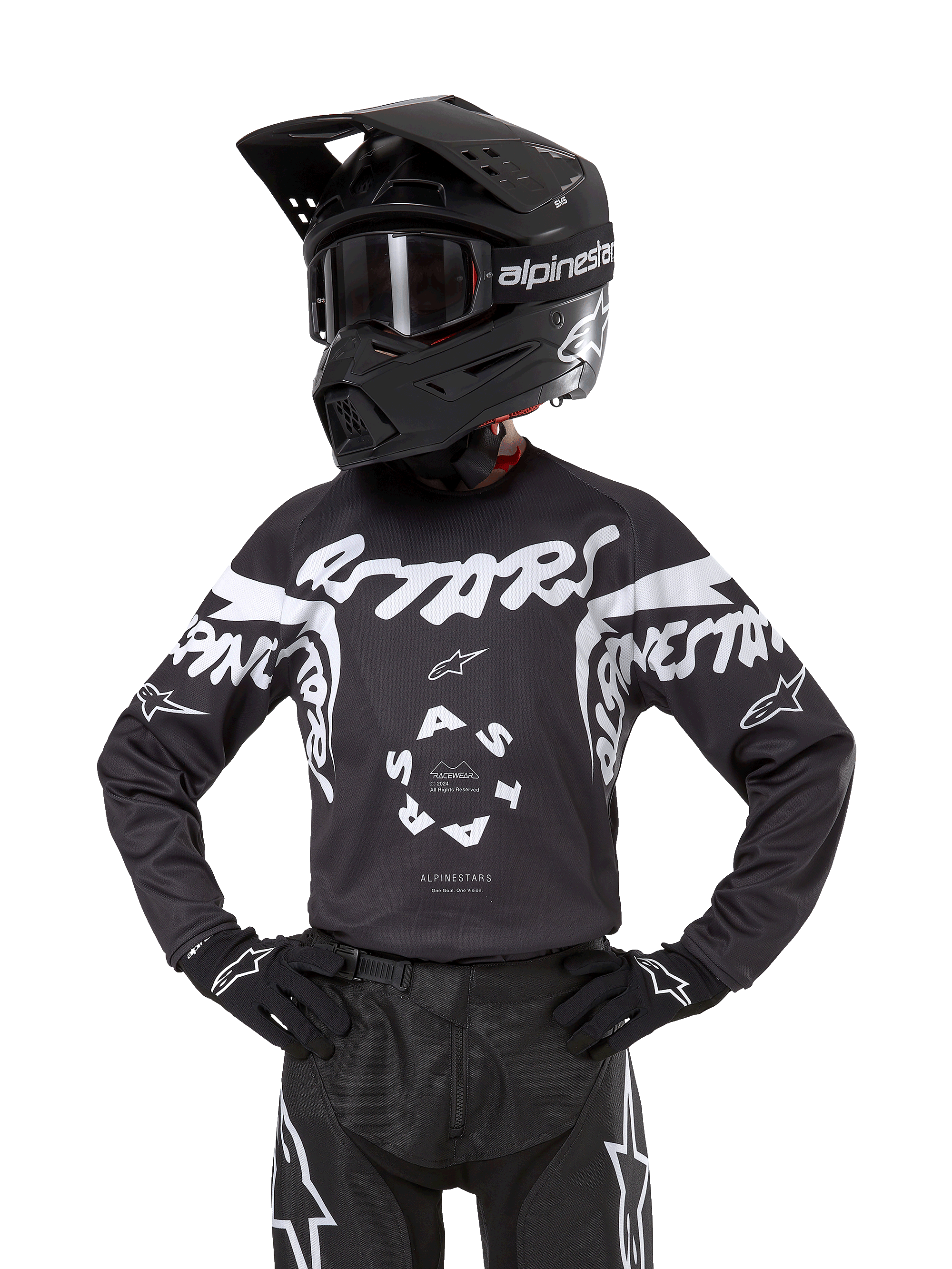 Alpinestars 2024 Youth Racer Hana Jersey, camiseta de motocross para jóvenes, negra con gráficos blancos, diseño deportivo con logos ASTARS y Alpinestars, mostrada con casco negro, gafas, guantes y pantalones de competición a juego