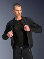 Alpinestars Troop-Air Pro Jacket, Black, premium technical armored air jacket with mesh construction, worn open over a black base layer with a red logo, paired with matching mesh motorcycle pants, urban contemporary riding style