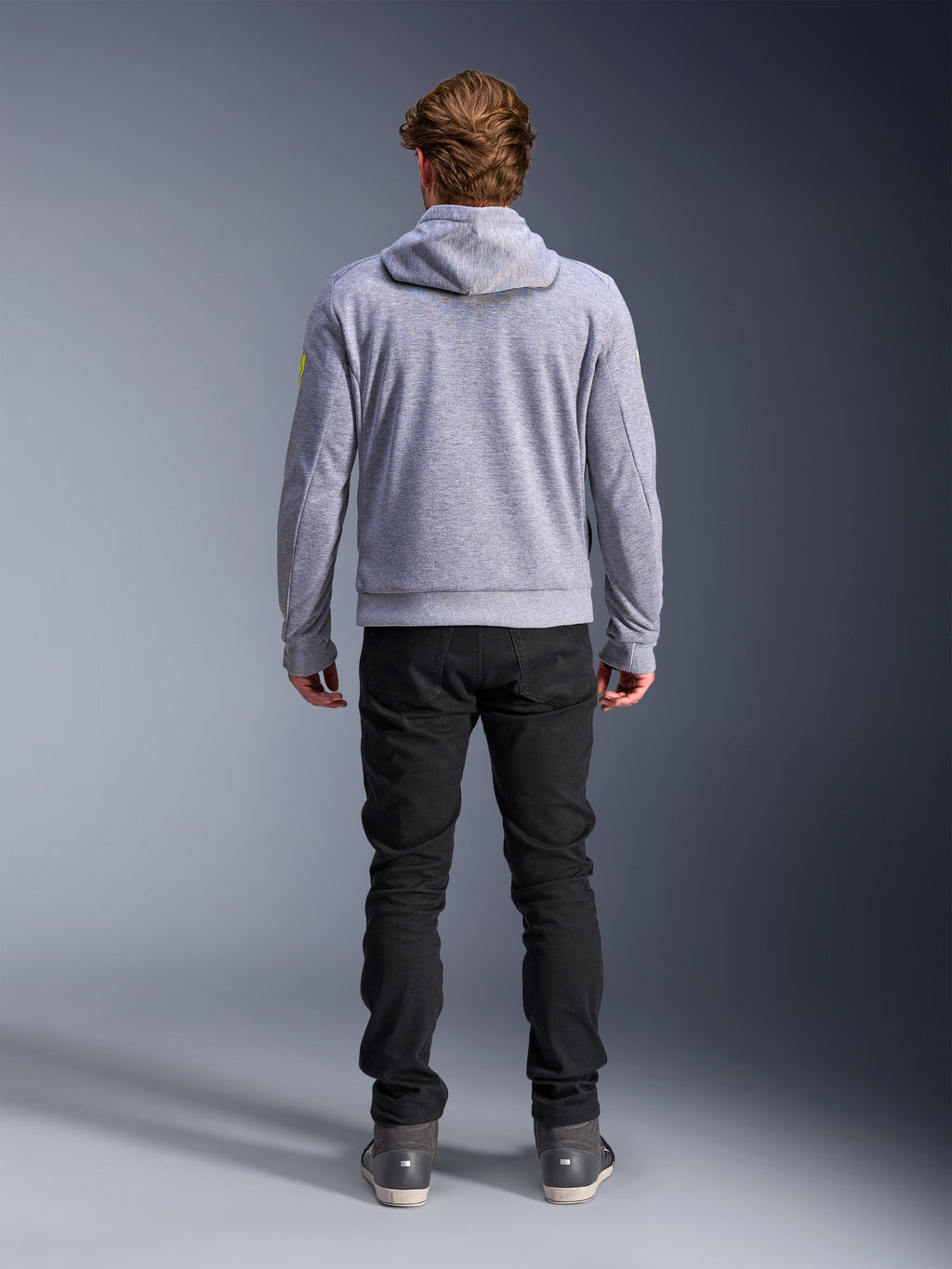 Alpinestars Chrome V2 Sport Hoodie, Gray Heather Fluo Yellow, back view of urban motorcycle riding gear, tech fleece hooded sweatshirt worn with black pants, featuring fluo yellow accents on the sleeves.