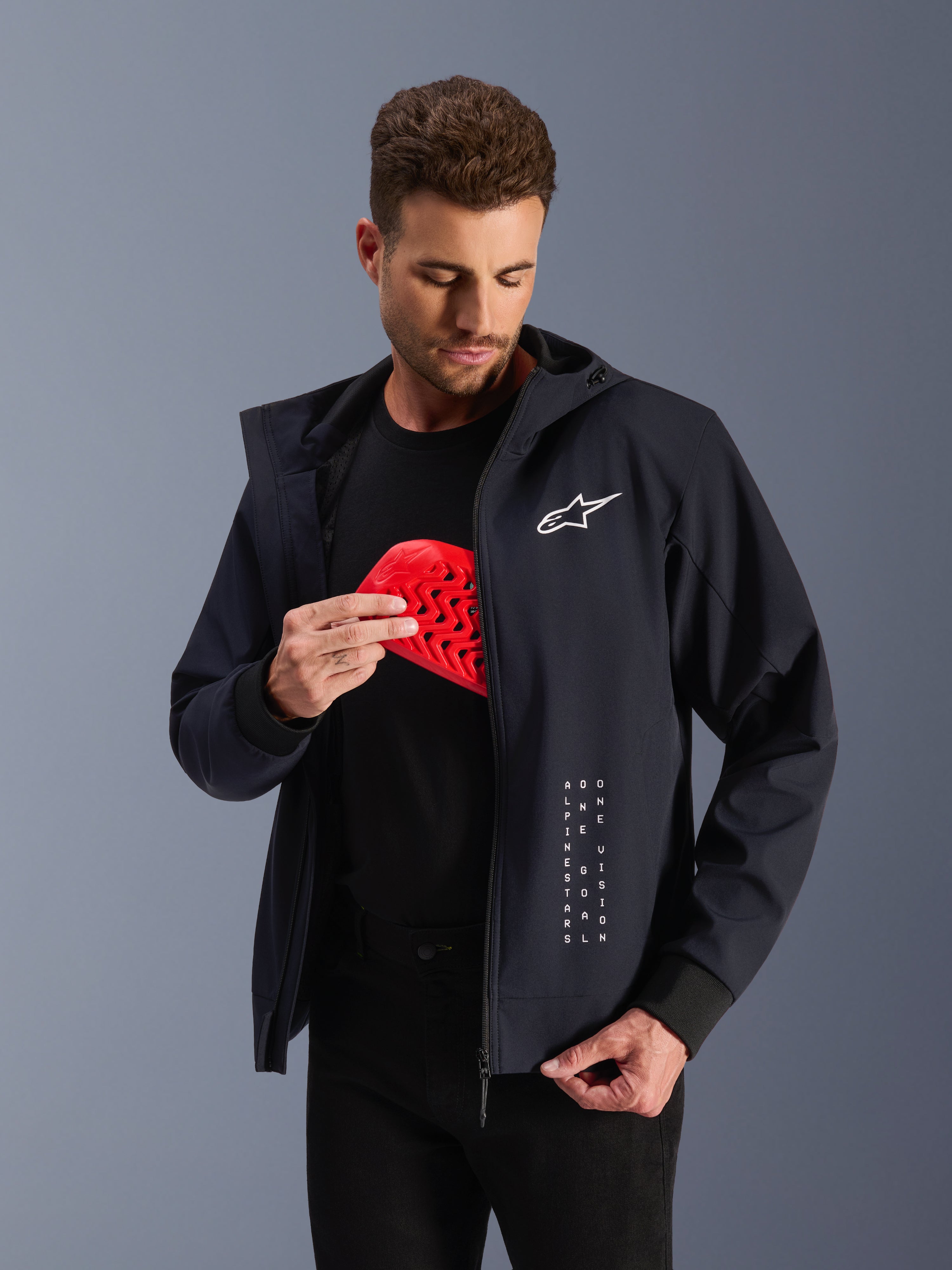Alpinestars Radium Tech Hoodie, black urban motorcycle jacket featuring a red Nucleon Flex Plus armor insert.