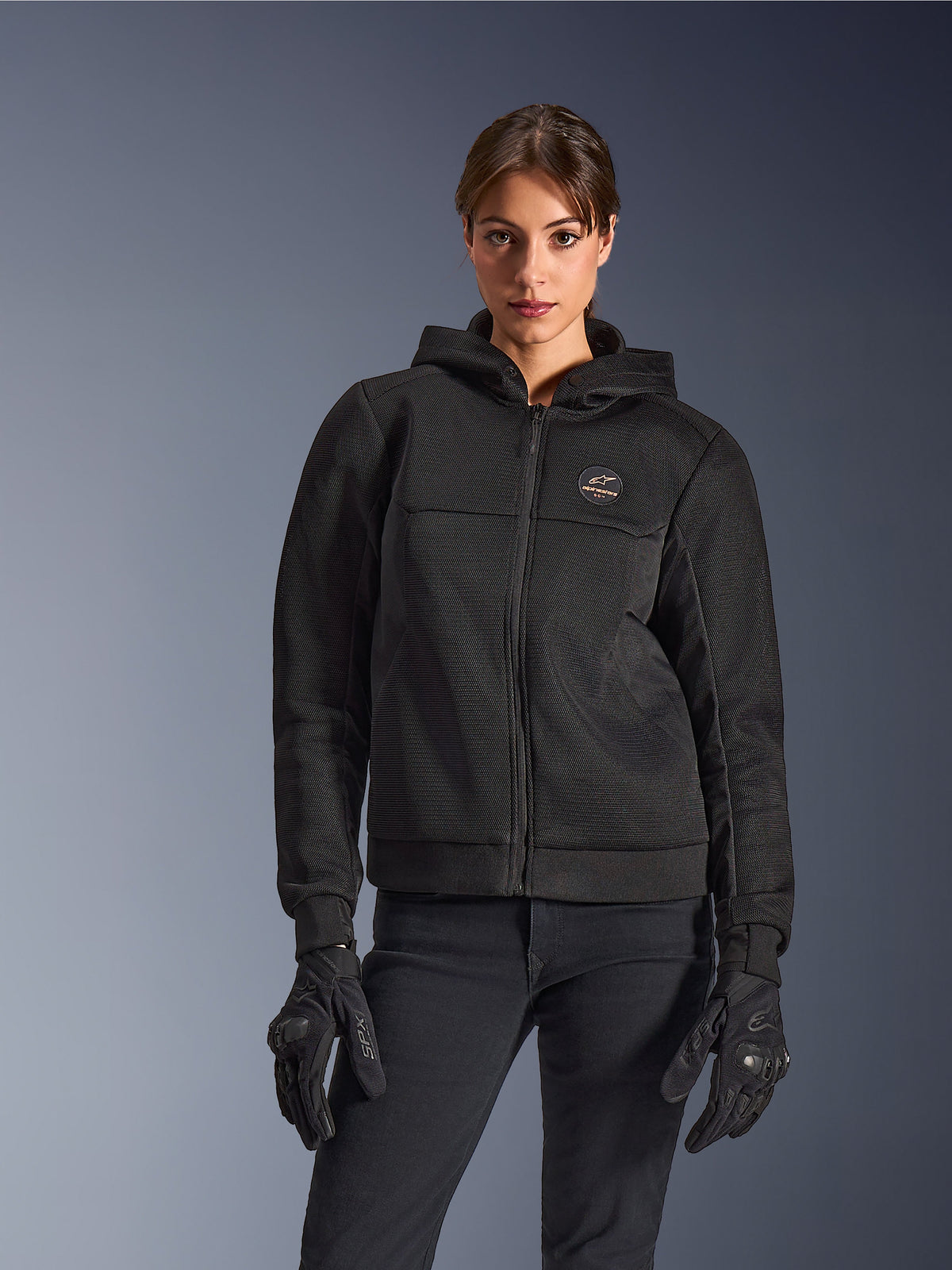Alpinestars Stella Chrome Superairflow Hoodie, sudadera de moto para mujer, negra, chaqueta con capucha con logotipo en el pecho y cremallera central, combinada con guantes negros, diseño moderno y elegante para la conducción urbana
