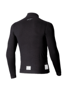 Camiseta de manga larga Alpinestars ZX Evo V3, capa base negra para automovilismo, vista posterior con un pequeño logo gris en el cuello y etiquetas de certificación FIA/SFI blancas en el dobladillo inferior, diseño ligero y resistente a las llamas.