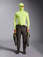 Alpinestars ZX Evo V3 Long Sleeve Top, Yellow Fluo, worn with matching balaclava and dark racing suit tied at waist, lightweight flame-resistant base layer for auto racing, featuring Alpinestars logos on the collar and shoulders