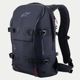 Alpinestars AMP-7 Backpack, technical motorcycle riding pack, Black with red zipper accents, featuring four adjustable compression straps with buckles, structured padded walls, Alpinestars logo on top and side branding, ergonomic shoulder straps for adventure and road touring.