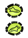 Alpinestars GP Plus Knee Slider, Motorcycle Racing Knee Sliders, Yellow Fluo and Black, left and right pair featuring a black star logo on a glossy yellow surface, textured black edges with "alpinestars" and "ONE GOAL ONE VISION" branding, designed for track abrasion