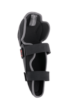Alpinestars Bionic Action Knee Protector, rodillera de motocross, negro y gris, vista interior con sistema de doble correa elástica, acolchado de espuma y diseño ergonómico asimétrico para conducción off-road