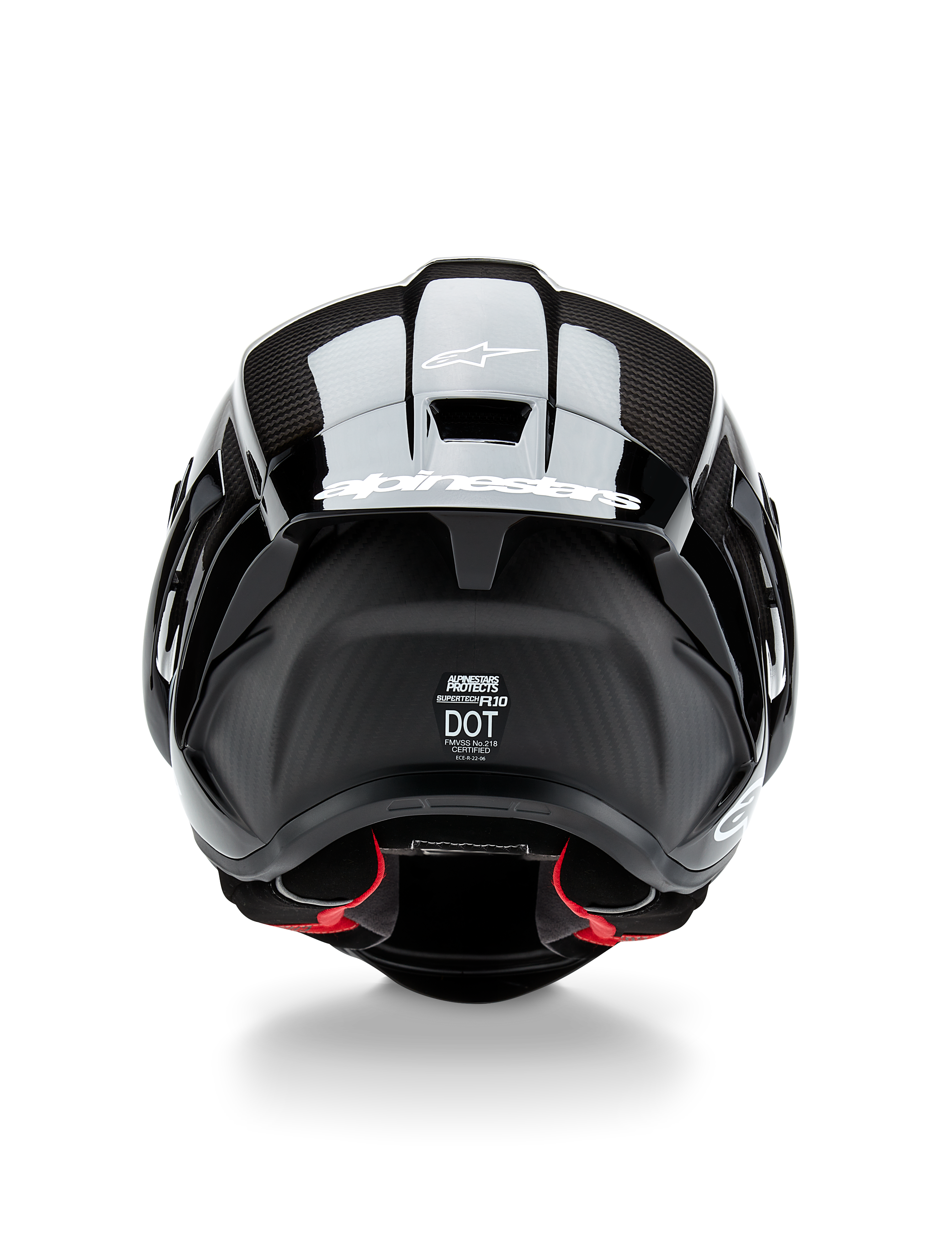 Alpinestars Supertech R10 Solid Helmet, Motorcycle Helmet, Black Carbon Matte and Glossy, rear view featuring carbon fiber texture, aerodynamic spoiler with white Alpinestars logo, DOT and ECE safety certification labels, and red interior padding