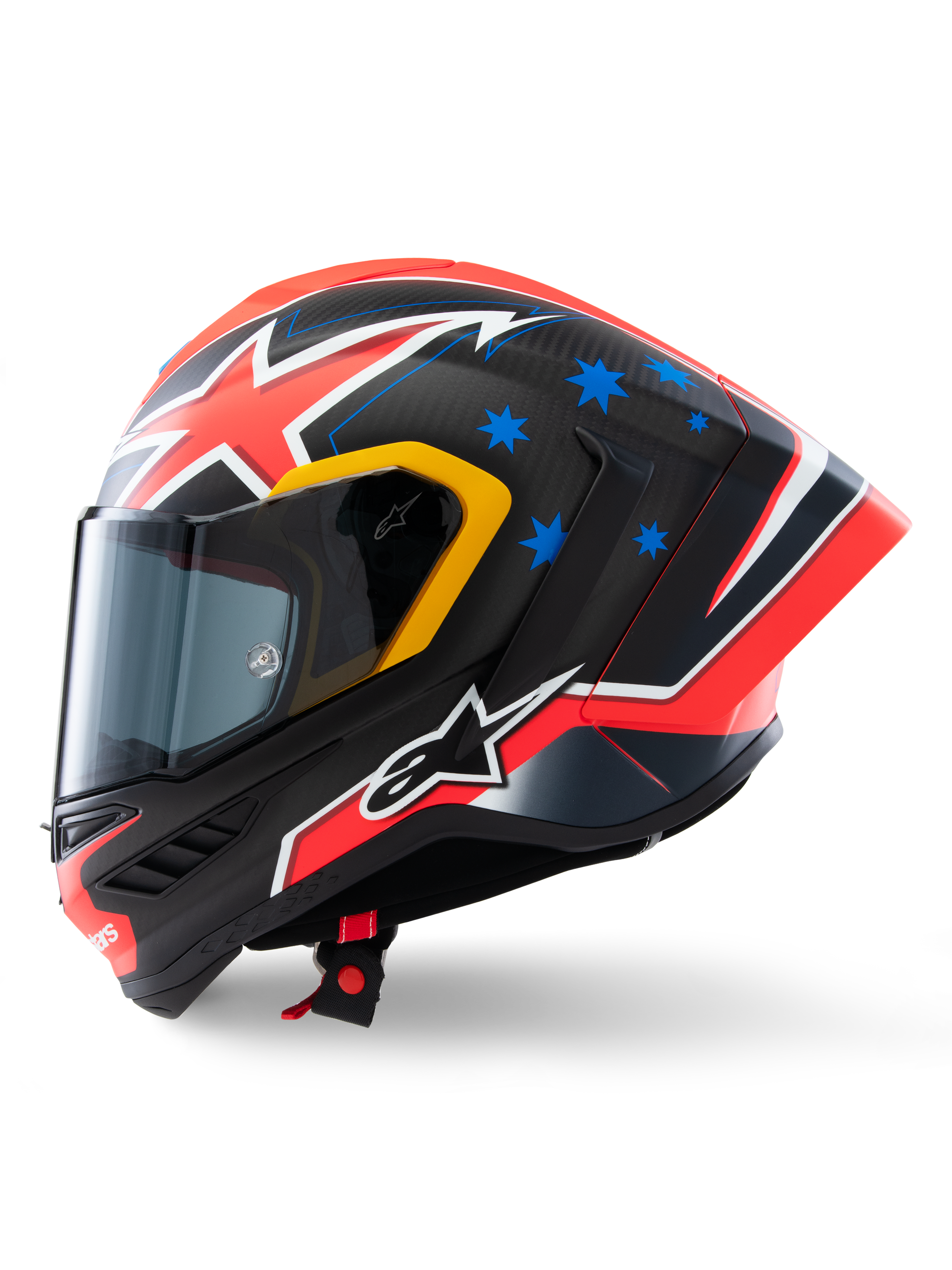Alpinestars Supertech R10 Miller Limited Edition Helmet, side profile, Carbon Red Matt finish with visible carbon fiber weave, featuring red and white lightning graphics, blue stars on the rear, yellow accents around the visor, and white Alpinestars logo, high-performance racing motorcycle helmet