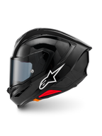 Casco Alpinestars S-R7 Solid, casco de moto integral, Negro Brillante, vista de perfil lateral con el logotipo blanco de Alpinestars, calota aerodinámica con alerón integrado, visor tintado y detalles rojos del sistema de liberación de emergencia.