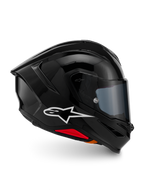 Casco Alpinestars S-R7 Solid, casco de moto integral, negro brillante, vista de perfil con logotipo A-star blanco, calota aerodinámica con alerón integrado y detalles en rojo en la base, diseñado para competición y rendimiento deportivo.