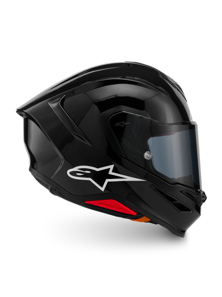 Casco Alpinestars S-R7 Solid, casco de moto integral, negro brillante, vista de perfil con logotipo A-star blanco, calota aerodinámica con alerón integrado y detalles en rojo en la base, diseñado para competición y rendimiento deportivo.
