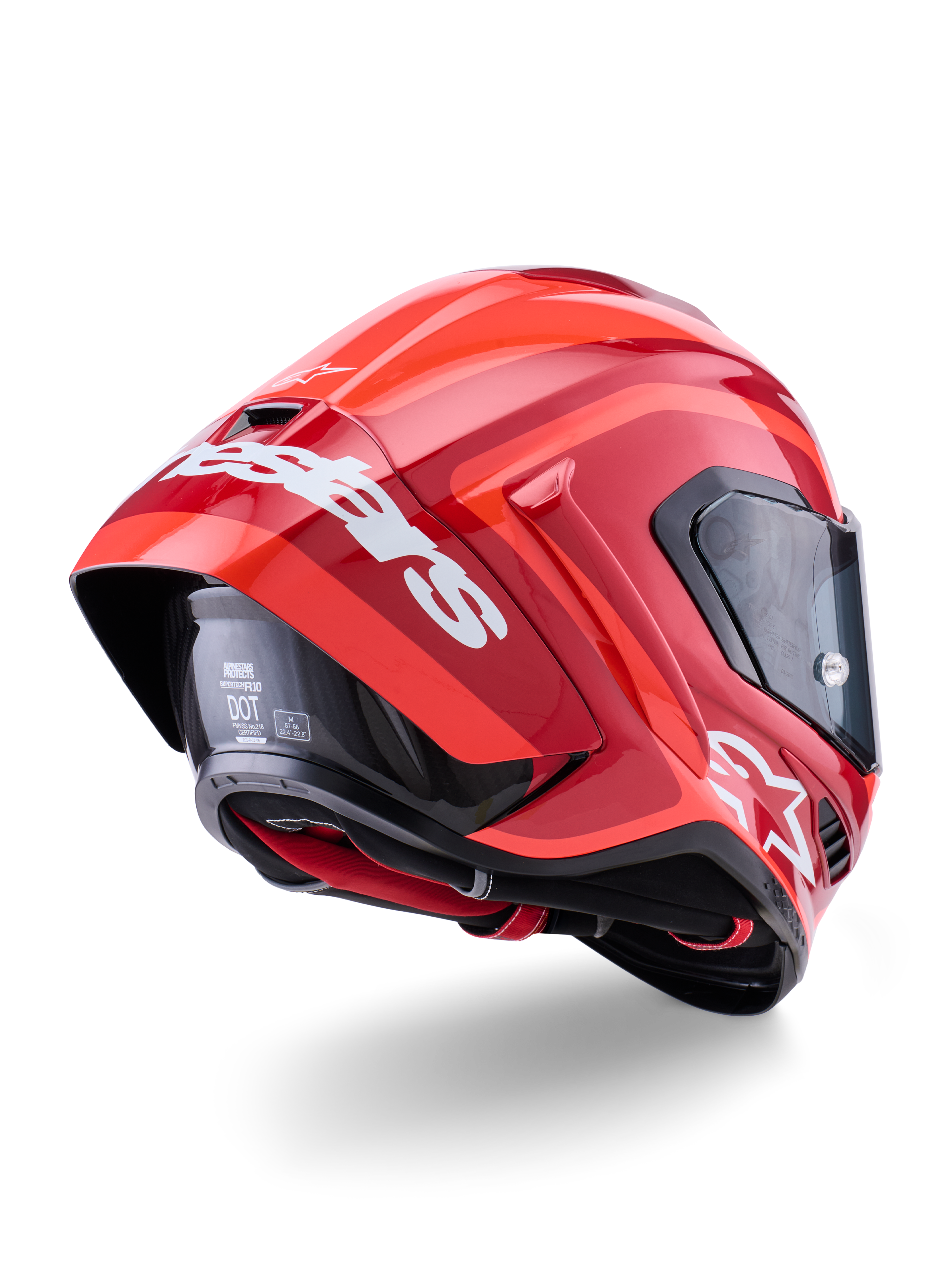 Alpinestars Supertech R10 Arius Helmet, Glossy Red with white branding, Rear three-quarter view showing aerodynamic spoiler, carbon fiber shell construction, and sleek racing profile with a dark visor