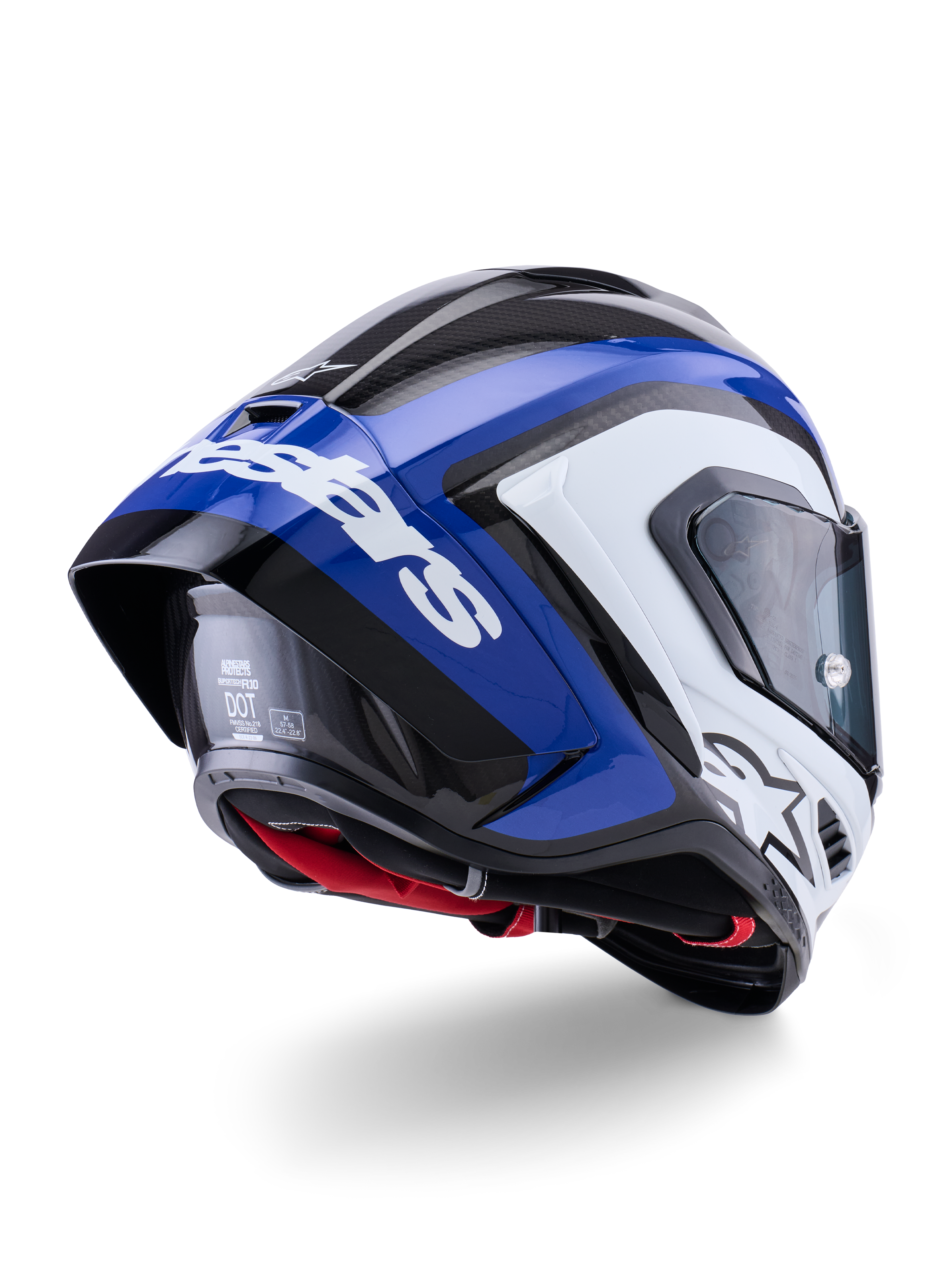 Casco Alpinestars Supertech R10 Arius, casco integral de competición, negro, blanco y azul brillante, vista trasera de tres cuartos que muestra el spoiler aerodinámico, textura de fibra de carbono visible y el logotipo de Alpinestars en blanco