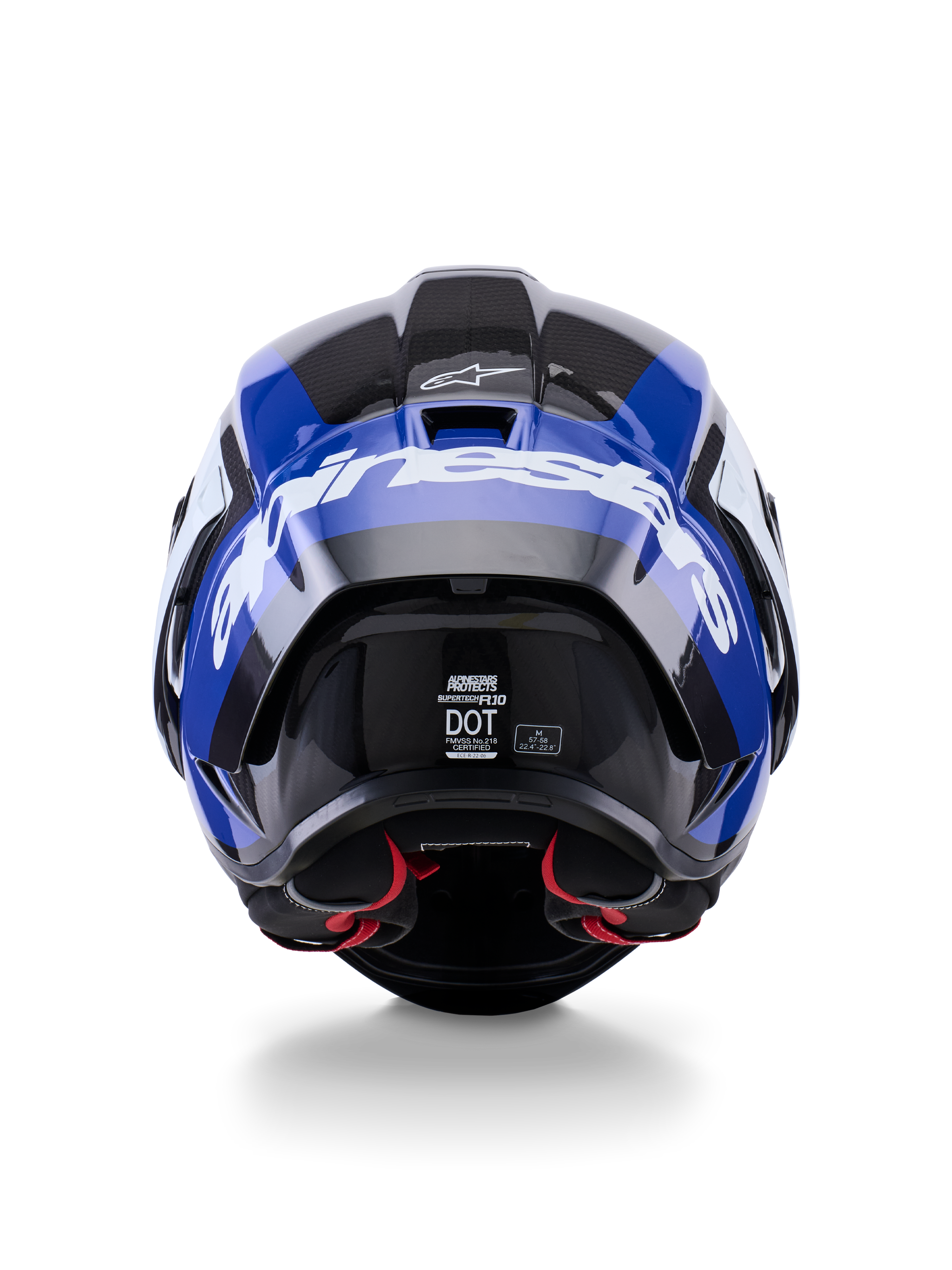 Casco Alpinestars Supertech R10 Arius, vista trasera, negro, blanco y azul brillante, construcción en fibra de carbono con logotipo blanco prominente, forma aerodinámica, etiqueta con certificación DOT y acolchado interior rojo