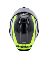 Alpinestars Supertech R10 Arius Helmet, top-down view, Black Silver and Yellow Fluo Glossy, carbon fiber shell with vibrant fluorescent yellow stripes, aerodynamic top ventilation ports, and Alpinestars branding, high-performance racing helmet