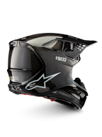 Alpinestars Supertech M10 Solid ECE 22.06, casco de motocross negro de carbono brillante, vista lateral con puertos de ventilación y visera de pico, certificado ECE