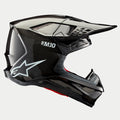 Casco Alpinestars Supertech M10 Solid, carbono negro brillante, casco de motocross, vista de perfil lateral que muestra el tejido de fibra de carbono brillante, marca S-M10, logotipo de la estrella de Alpinestars en blanco, diseño aerodinámico con visera y puertos de ventilación