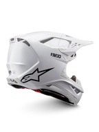 Alpinestars Supertech M10 Solid ECE 22.06, casco de motocross blanco brillante con gráficos negros, detalles rojos, puertos de ventilación y visor de pico