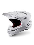 Alpinestars Casco Supertech M10 Solid ECE 22.06, casco de motocross blanco brillante con acolchado interior negro y rojo, visor superior y múltiples puertos de ventilación, vista de tres cuartos