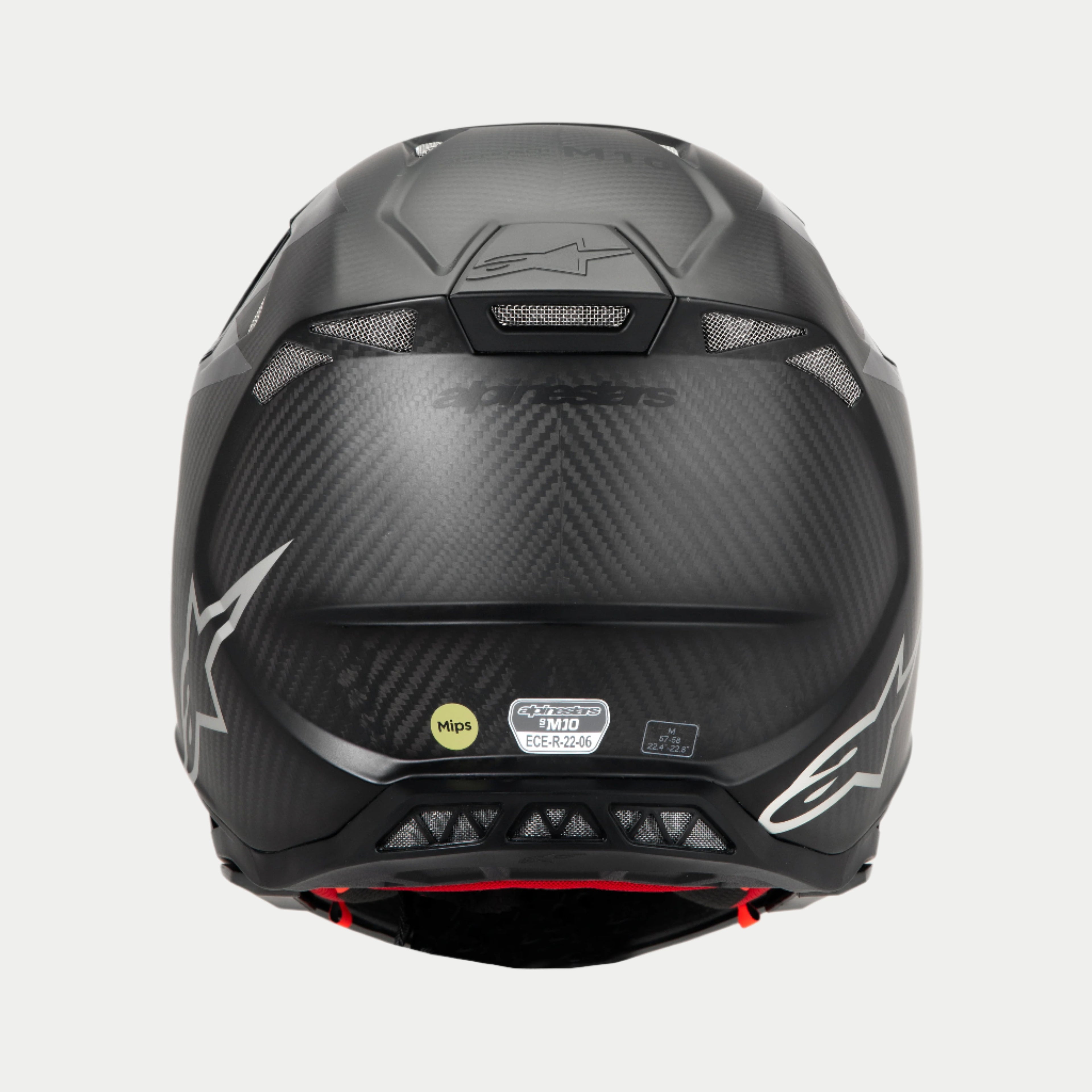 Casco Alpinestars Supertech M10 Fame ECE 22.06, vista trasera, carbono negro mate y brillante, con tejido de fibra de carbono visible, puertos de ventilación de malla, etiquetas de certificación MIPS y ECE, y logotipo de Alpinestars.