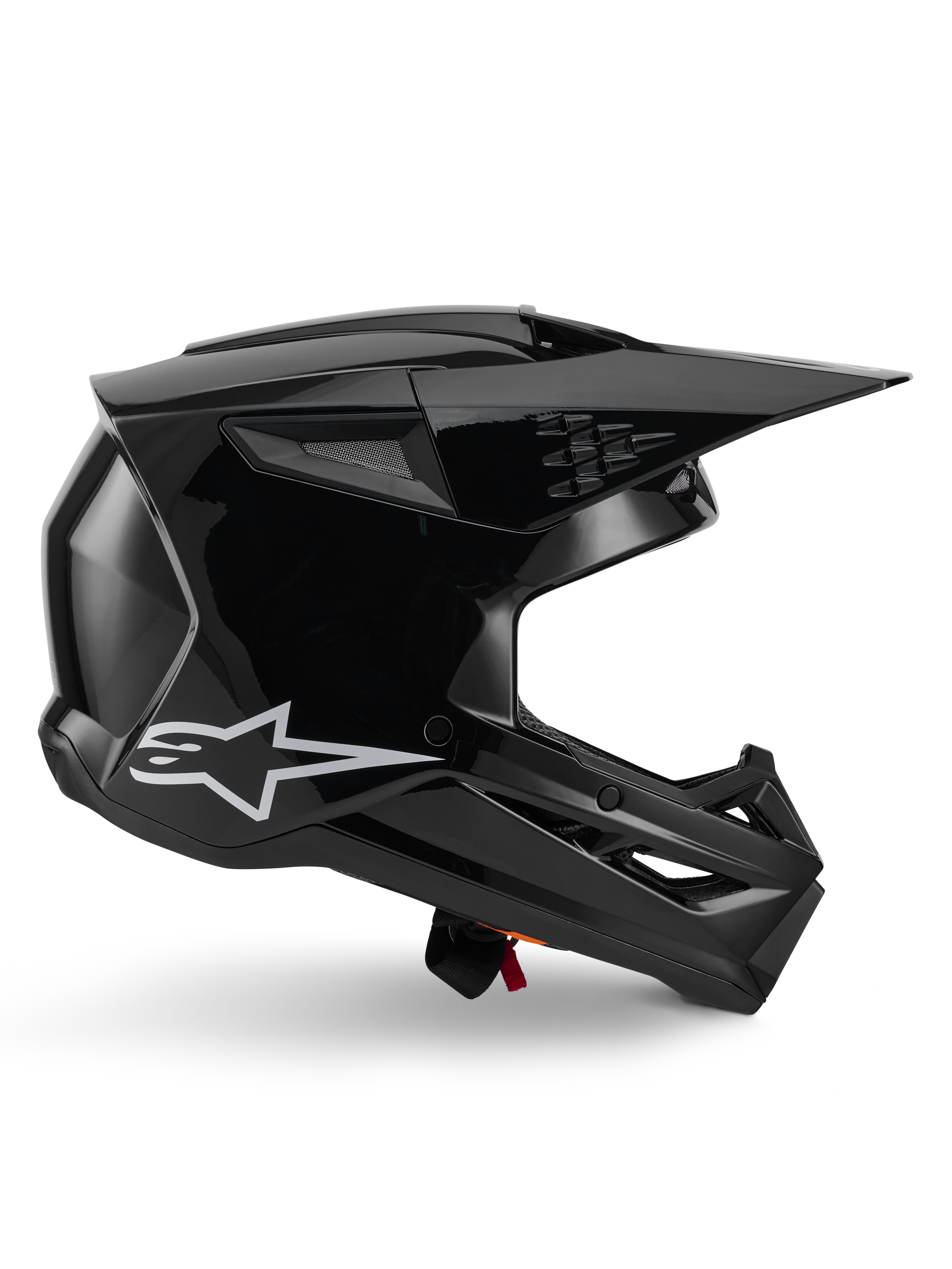 Alpinestars S-M3 Solid Helmet, casco de motocross, negro brillante, vista de perfil lateral con el logo de la estrella blanca, diseño aerodinámico angular con ventilaciones de malla y visera, equipo de protección para carreras off-road