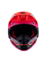 Casco Alpinestars Supertech M10 Deegan Monster ECE 22.06, vista frontal de casco de motocross en naranja flúor, púrpura y rosa brillante, con logotipos de la garra de Monster Energy en la mentonera negra, diseño aerodinámico con puertos de ventilación integrados, protección de cabeza premium para carreras off-road