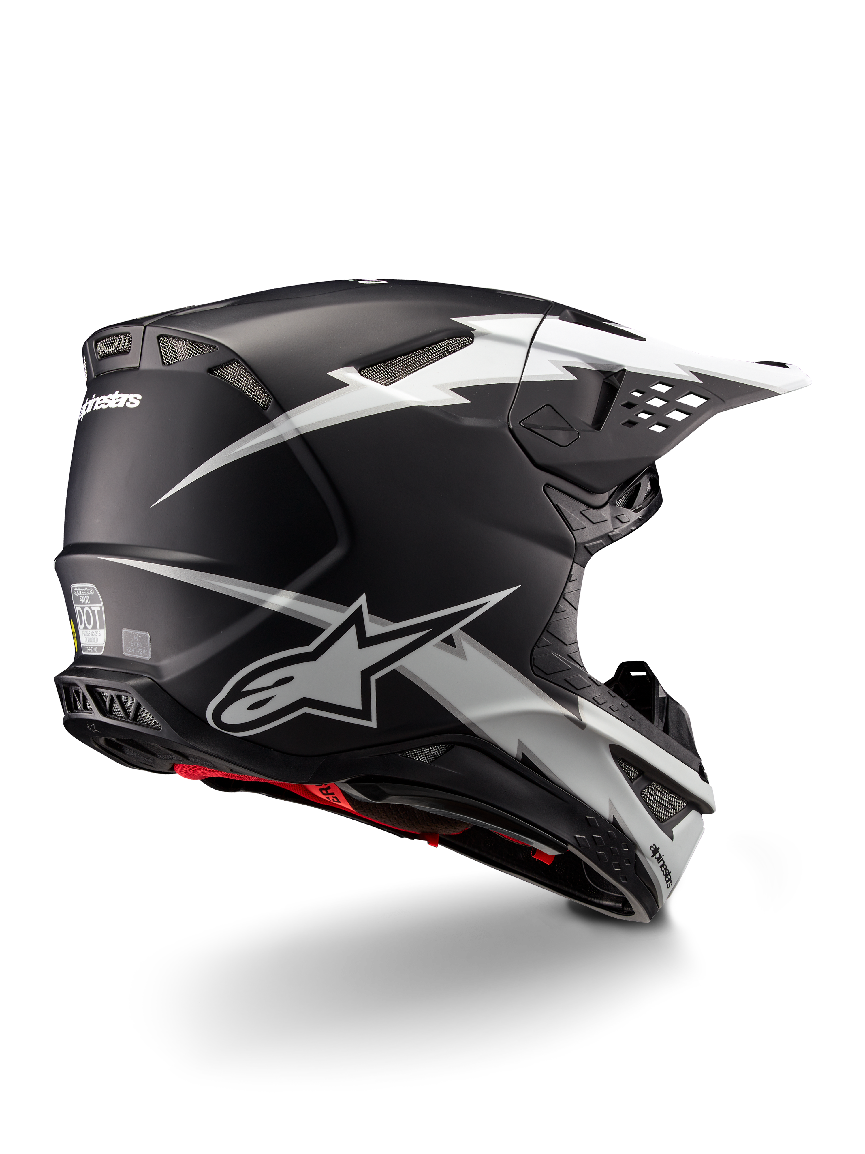 Casco Alpinestars Supertech M10 Ampress, casco de motocross, negro y blanco mate, con llamativos gráficos de rayos blancos sobre una calota negra mate, vista trasera de tres cuartos que muestra el logotipo de Alpinestars y los puertos de ventilación