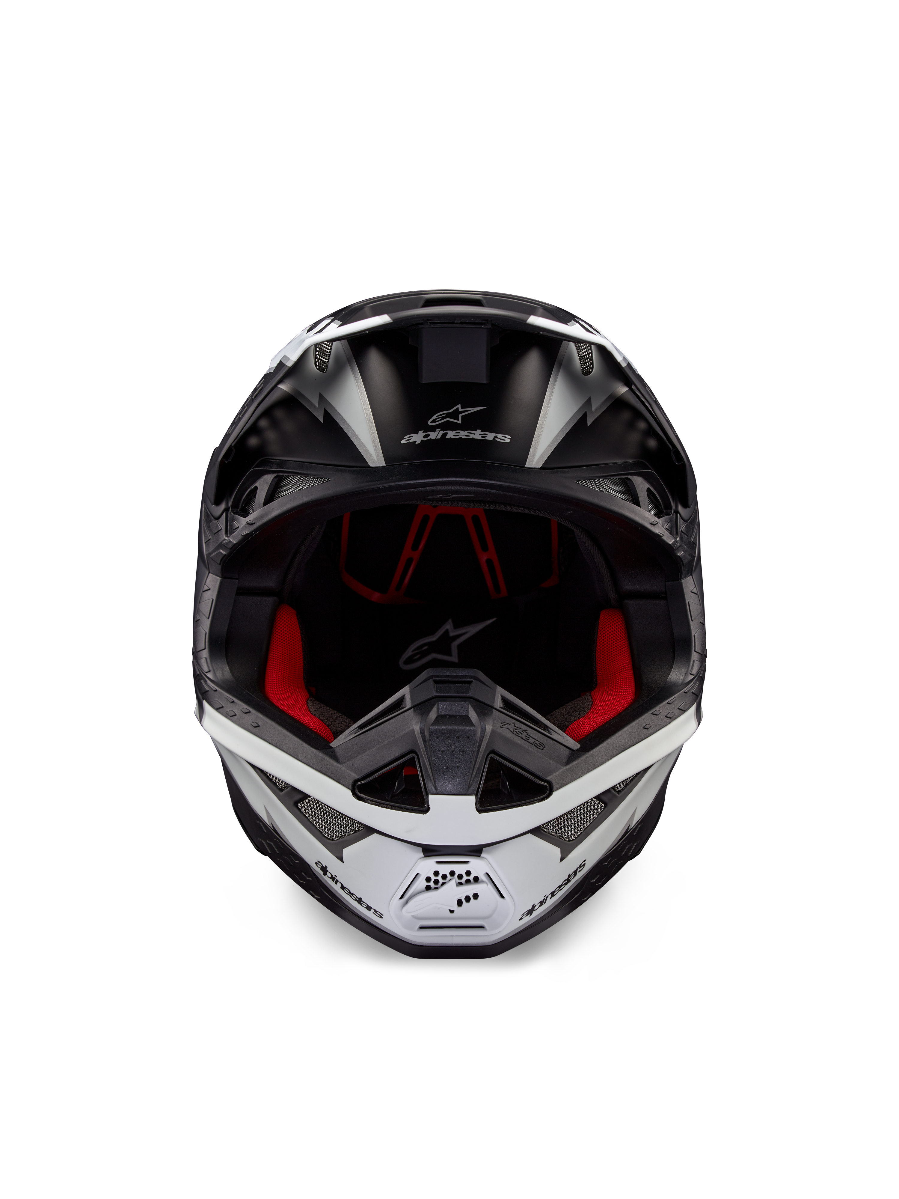 Casco Alpinestars Supertech M10 Ampress, casco de motocross, negro y blanco mate, vista frontal con forro interior rojo, carcasa aerodinámica con puertos de ventilación y logotipo de Alpinestars