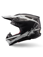 Casco Alpinestars Supertech M10 Ampress, casco de motocross, negro mate y blanco, vista de perfil con llamativos gráficos blancos estilo rayo, carcasa aerodinámica con puertos de ventilación visibles y visera, protección avanzada para todoterreno