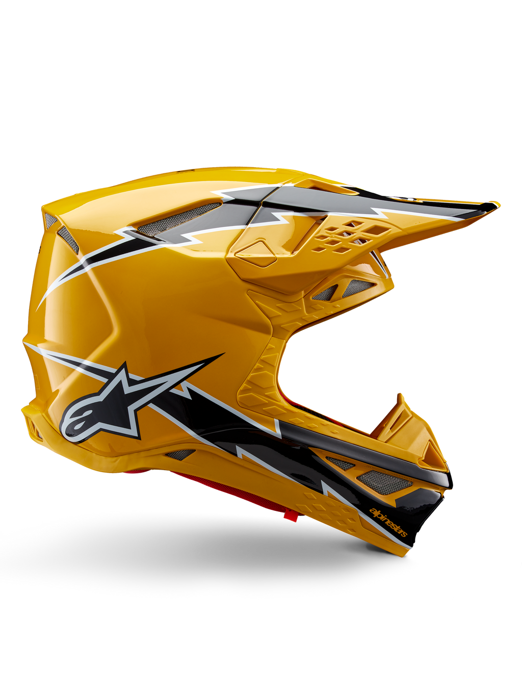 Casco Alpinestars Supertech M10 Ampress, casco de motocross, amarillo y negro brillante, perfil lateral con llamativos gráficos de rayos en blanco y negro, logotipo de la estrella de Alpinestars, diseño aerodinámico con puertos de ventilación integrados y visera ajustable.
