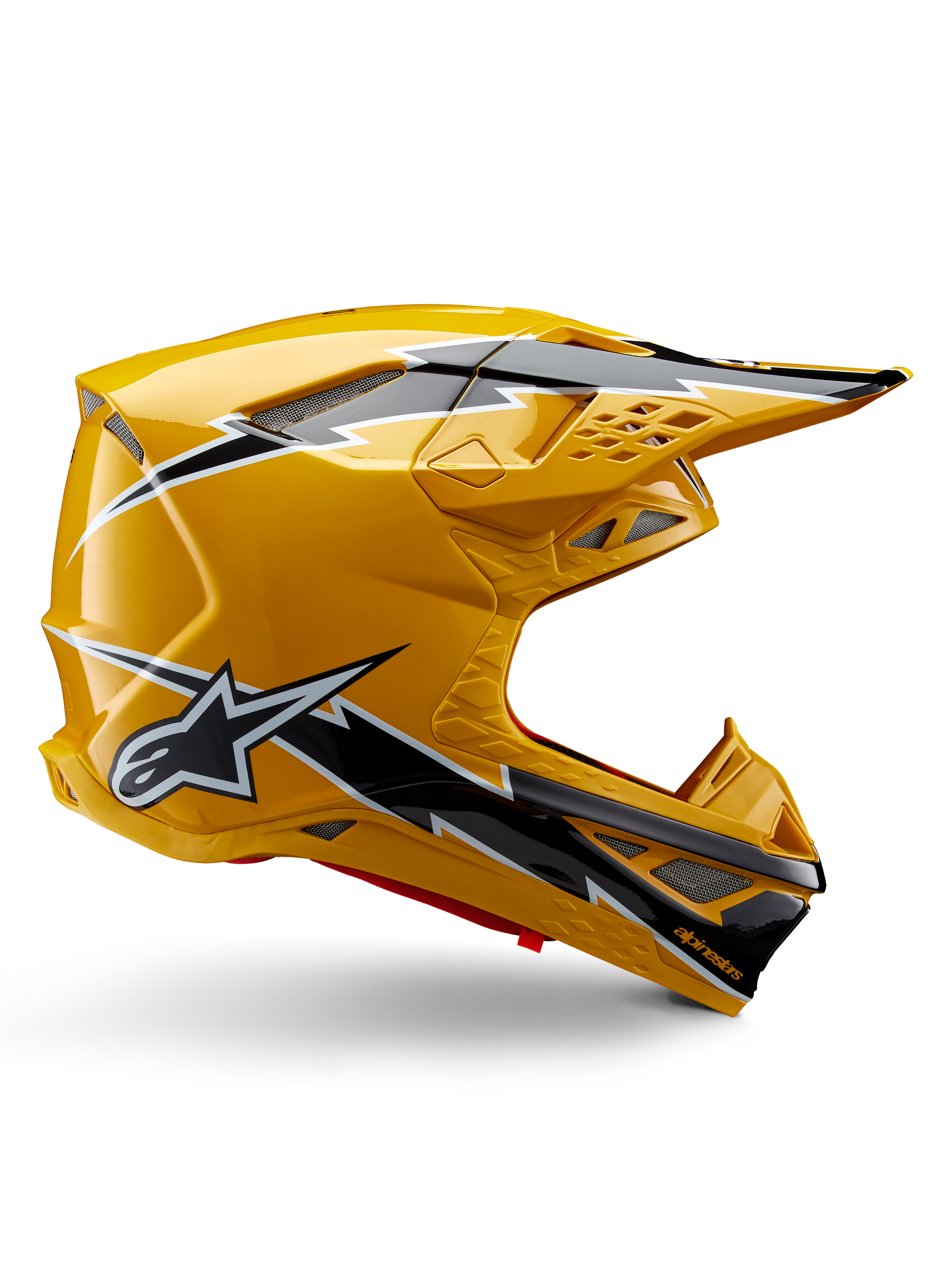 Casco Alpinestars Supertech M10 Ampress, casco de motocross, amarillo y negro brillante, perfil lateral con llamativos gráficos de rayos en blanco y negro, logotipo de la estrella de Alpinestars, diseño aerodinámico con puertos de ventilación integrados y visera ajustable.