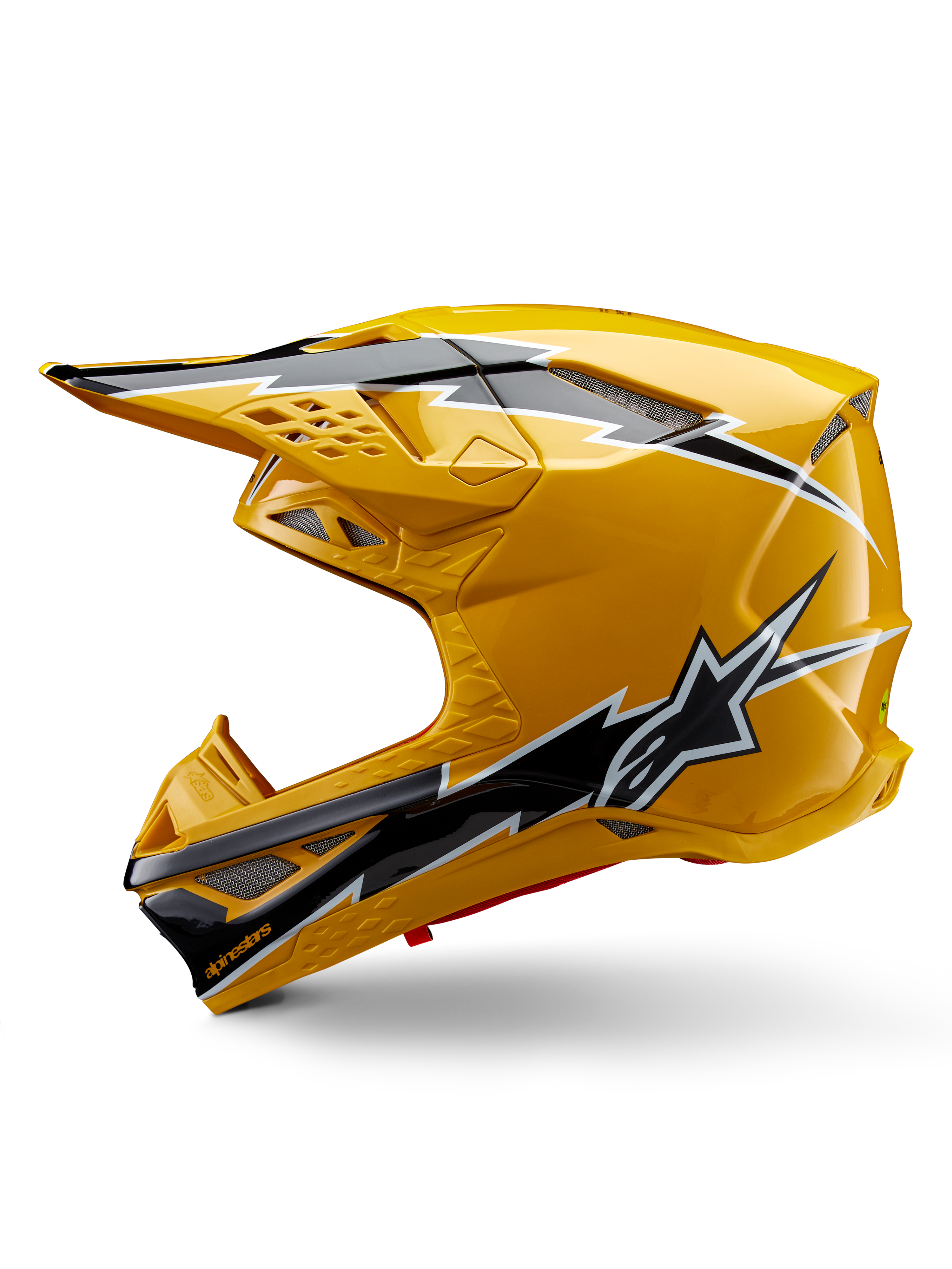 Casco Alpinestars Supertech M10 Ampress, casco de motocross, amarillo brillante con gráficos en negro y blanco, vista lateral con diseños angulares llamativos, logotipo de la estrella de Alpinestars y múltiples puertos de ventilación con malla plateada, equipo profesional de carreras off-road