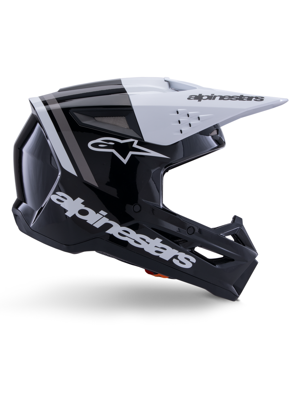 Casco Alpinestars S-M3 Radium, casco de motocross off-road, negro, blanco y gris brillante, con un diseño aerodinámico angular y puertos de ventilación, vista de perfil lateral, acabado brillante con franjas grises y visera blanca con el logotipo de Alpinestars