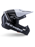 Casco Alpinestars S-M3 Radium, casco de motocross off-road, negro, blanco y gris brillante, con un diseño aerodinámico angular y puertos de ventilación, vista de perfil lateral, acabado brillante con franjas grises y visera blanca con el logotipo de Alpinestars