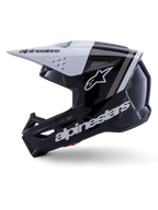Casco Alpinestars S-M3 Radium ECE 22.06, vista de perfil lateral, acabado brillante en blanco y negro, franjas de competición grises, logotipo de Alpinestars blanco en el lateral y en la zona del mentón, diseño ventilado para motocross y enduro