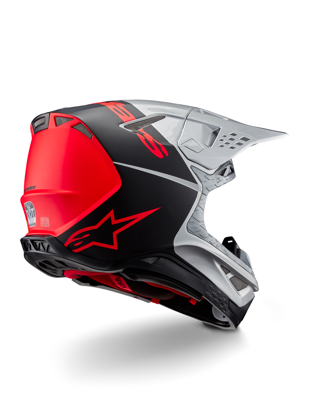 Casco Alpinestars Supertech M10 Flood ECE 22.06, casco de motocross, plateado, negro y naranja flúor, vista lateral trasera que destaca el diseño aerodinámico de la calota, los puertos de ventilación y el acabado mate y brillante