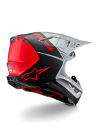 Casco Alpinestars Supertech M10 Flood ECE 22.06, casco de motocross, plateado, negro y naranja flúor, vista lateral trasera que destaca el diseño aerodinámico de la calota, los puertos de ventilación y el acabado mate y brillante