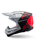 Casco Alpinestars Supertech M10 Flood, casco de motocross, plateado y negro con detalles en naranja fluorescente, perfil lateral, diseño aerodinámico elegante con puertos de ventilación, acabado mate y brillante, protección profesional para carreras off-road