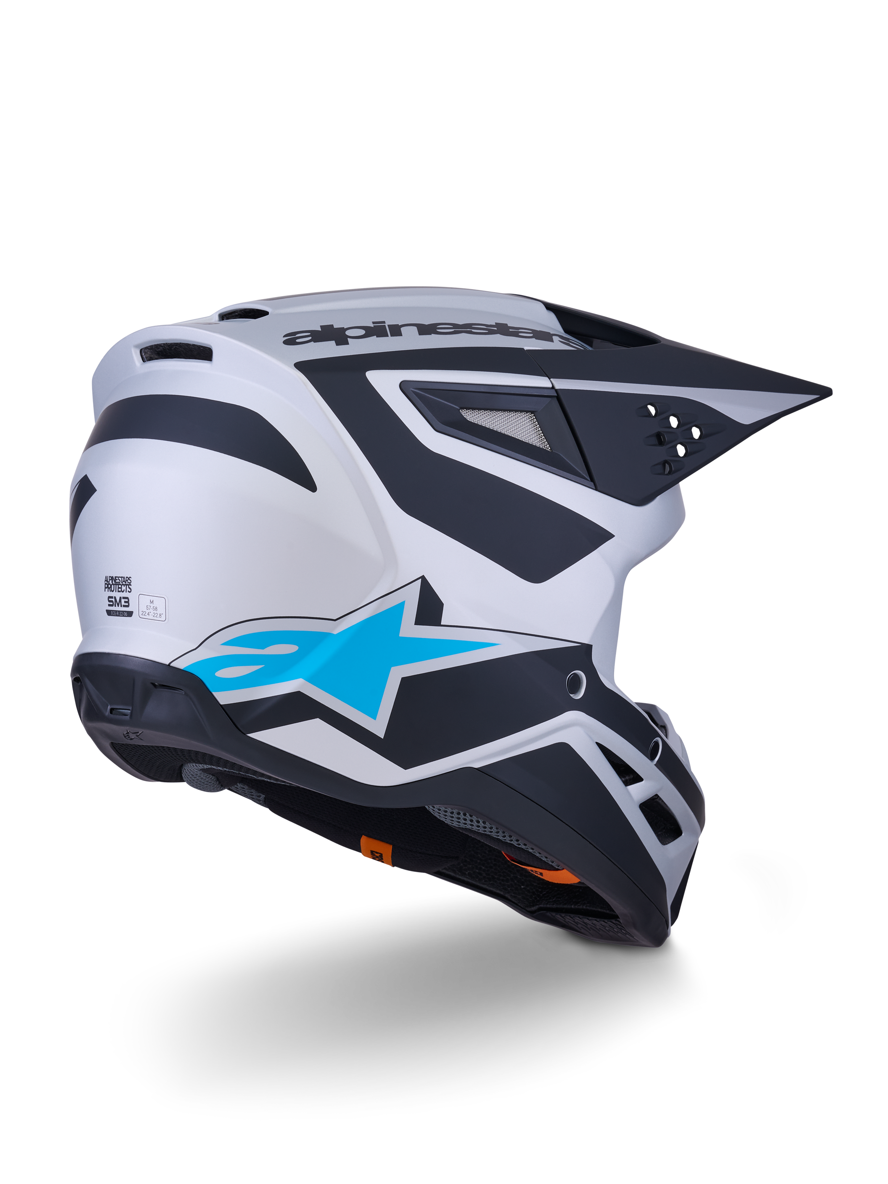 Casco Alpinestars S-M3 Heat ECE 22.06, casco de motocross, plata, azul y negro mate, vista trasera con un gran logotipo de estrella azul y diseños angulares negros, carcasa aerodinámica con puertos de ventilación, protección de alto rendimiento para carreras off-road