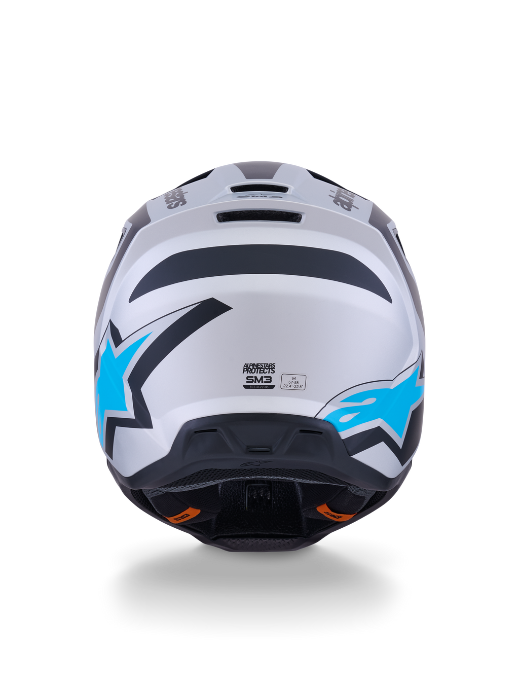 Casco Alpinestars S-M3 Heat, casco de motocross, color plata, azul y negro mate, vista trasera que muestra los logotipos de estrellas en azul brillante, acabado mate y puertos de ventilación integrados.