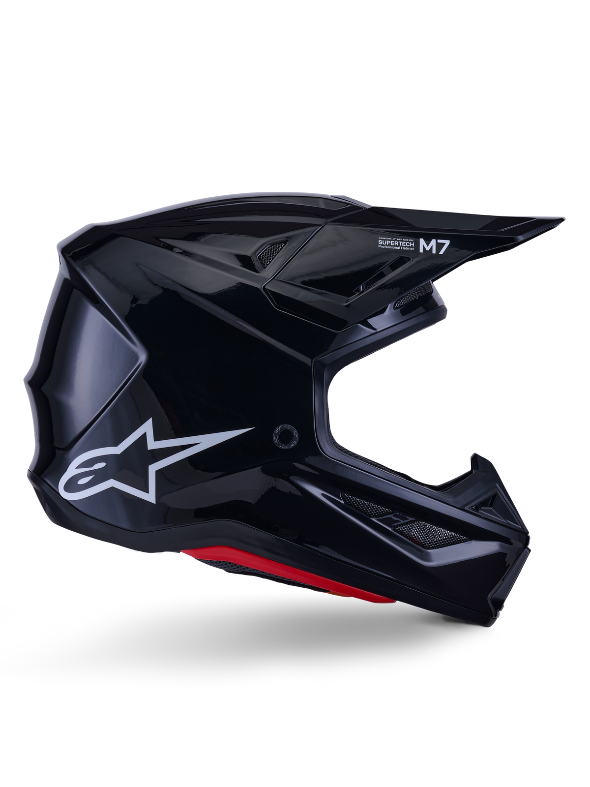 Alpinestars S-M7 Solid Helmet, casco de motocross, negro brillante con logotipo de estrella blanca y acentos rojos, perfil lateral con diseño aerodinámico, rejillas de ventilación angulares y marca Supertech M7 en la visera.