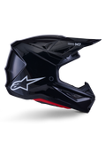 Alpinestars S-M7 Solid Helmet, casco de motocross, negro brillante con logotipo de estrella blanca y acentos rojos, perfil lateral con diseño aerodinámico, rejillas de ventilación angulares y marca Supertech M7 en la visera.