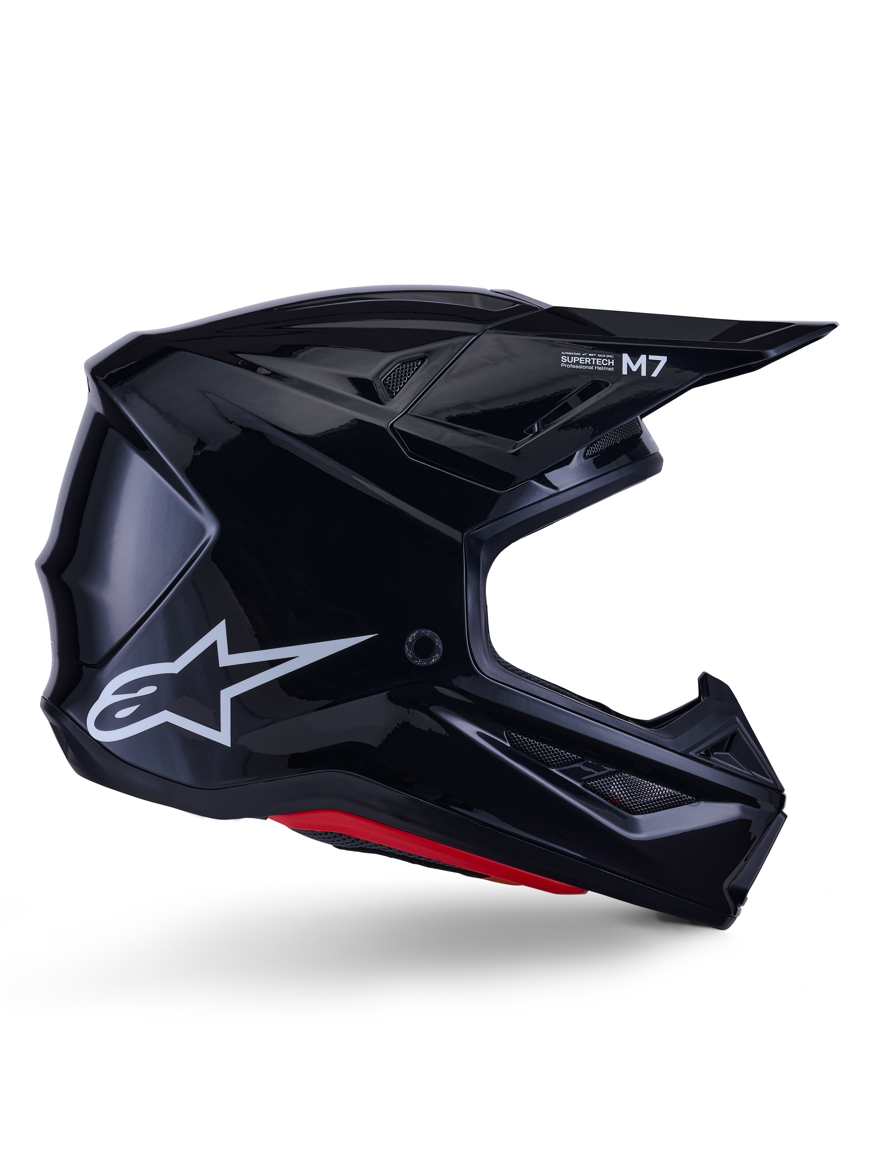 Alpinestars S-M7 Solid Helmet, casco de motocross, negro brillante con logotipo de estrella blanca y acentos rojos, perfil lateral con diseño aerodinámico, rejillas de ventilación angulares y marca Supertech M7 en la visera.