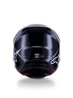 Alpinestars S-M7 Solid Helmet ECE 22.06, casco de motocross, negro brillante, vista trasera con logotipos de estrellas blancas, calota compuesta aerodinámica con acabado de alto brillo, etiquetas de certificación de seguridad y talla en el centro
