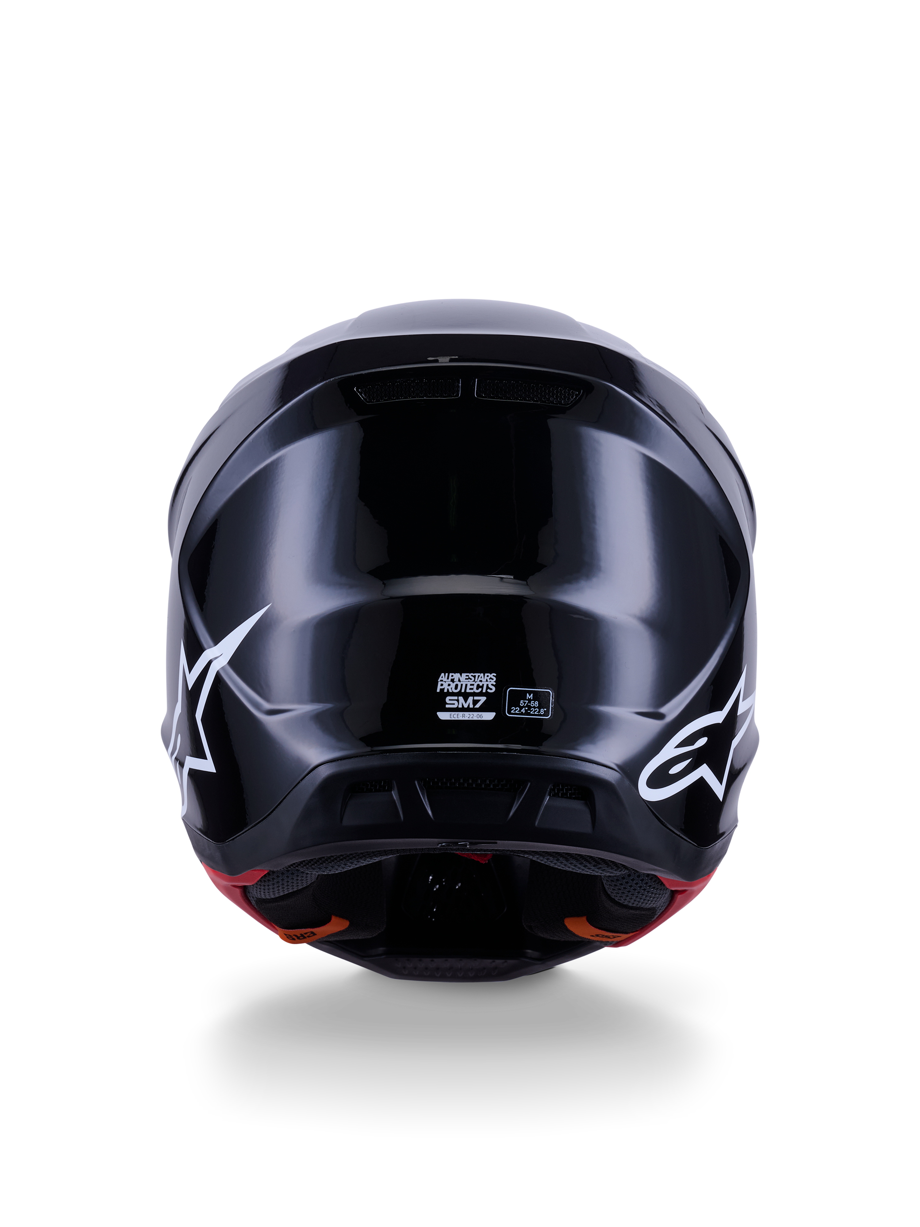 Alpinestars S-M7 Solid Helmet ECE 22.06, casco de motocross, negro brillante, vista trasera con logotipos de estrellas blancas, calota compuesta aerodinámica con acabado de alto brillo, etiquetas de certificación de seguridad y talla en el centro