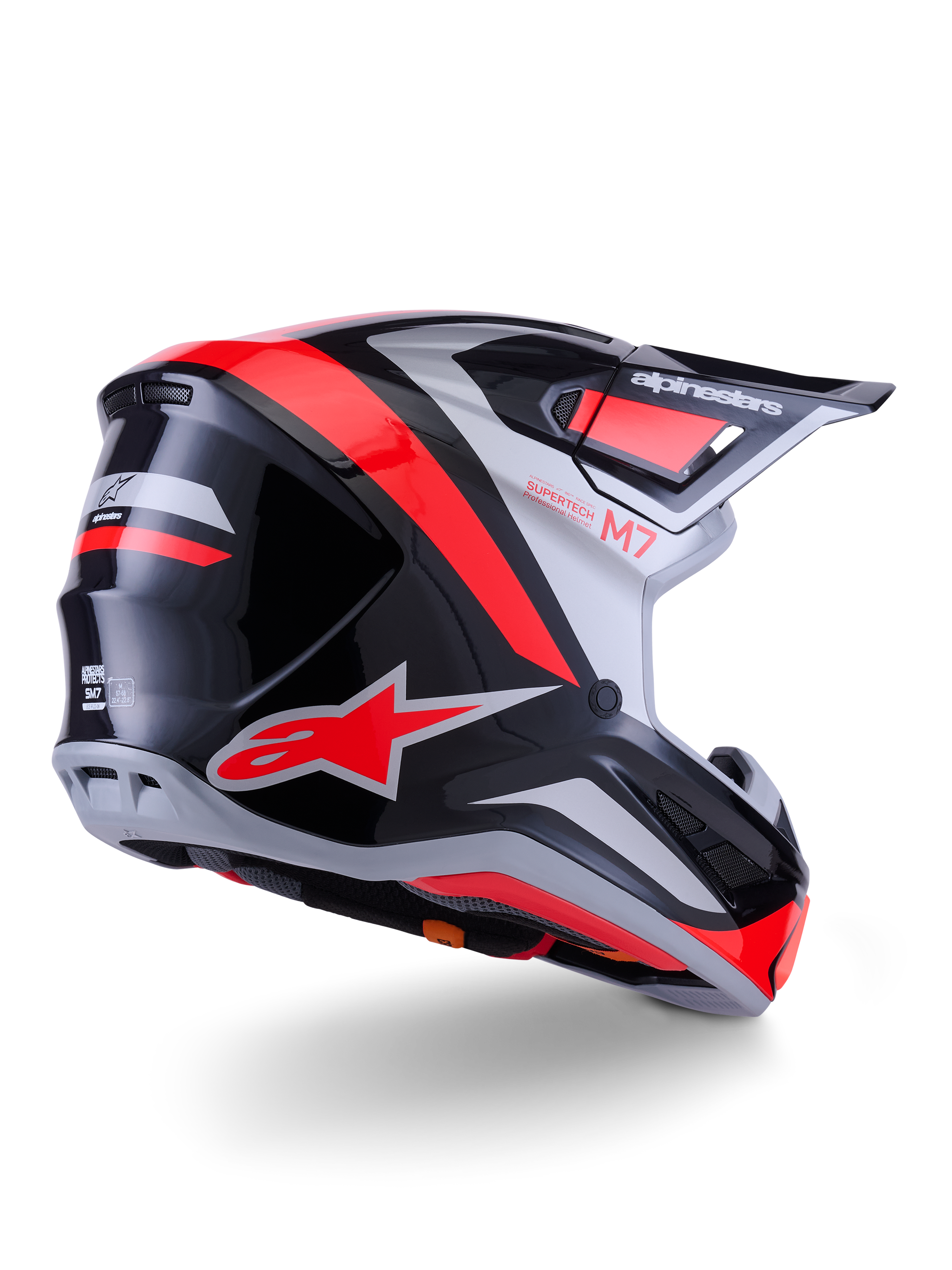 Alpinestars S-M7 Rise Helmet, casco de motocross, negro, plateado y rojo flúor brillante, vista trasera de tres cuartos, con el llamativo logotipo de la estrella en rojo y detalles plateados, calota aerodinámica con visera, protección profesional para carreras de motocross