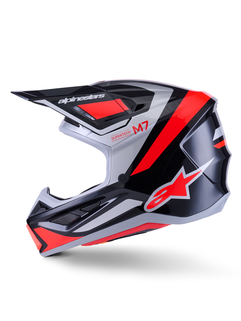 Casco Alpinestars S-M7 Rise, casco de motocross, negro, plata y rojo flúor brillante, vista de perfil lateral con calota aerodinámica de material compuesto, mentonera ventilada y visera prominente con la marca Alpinestars