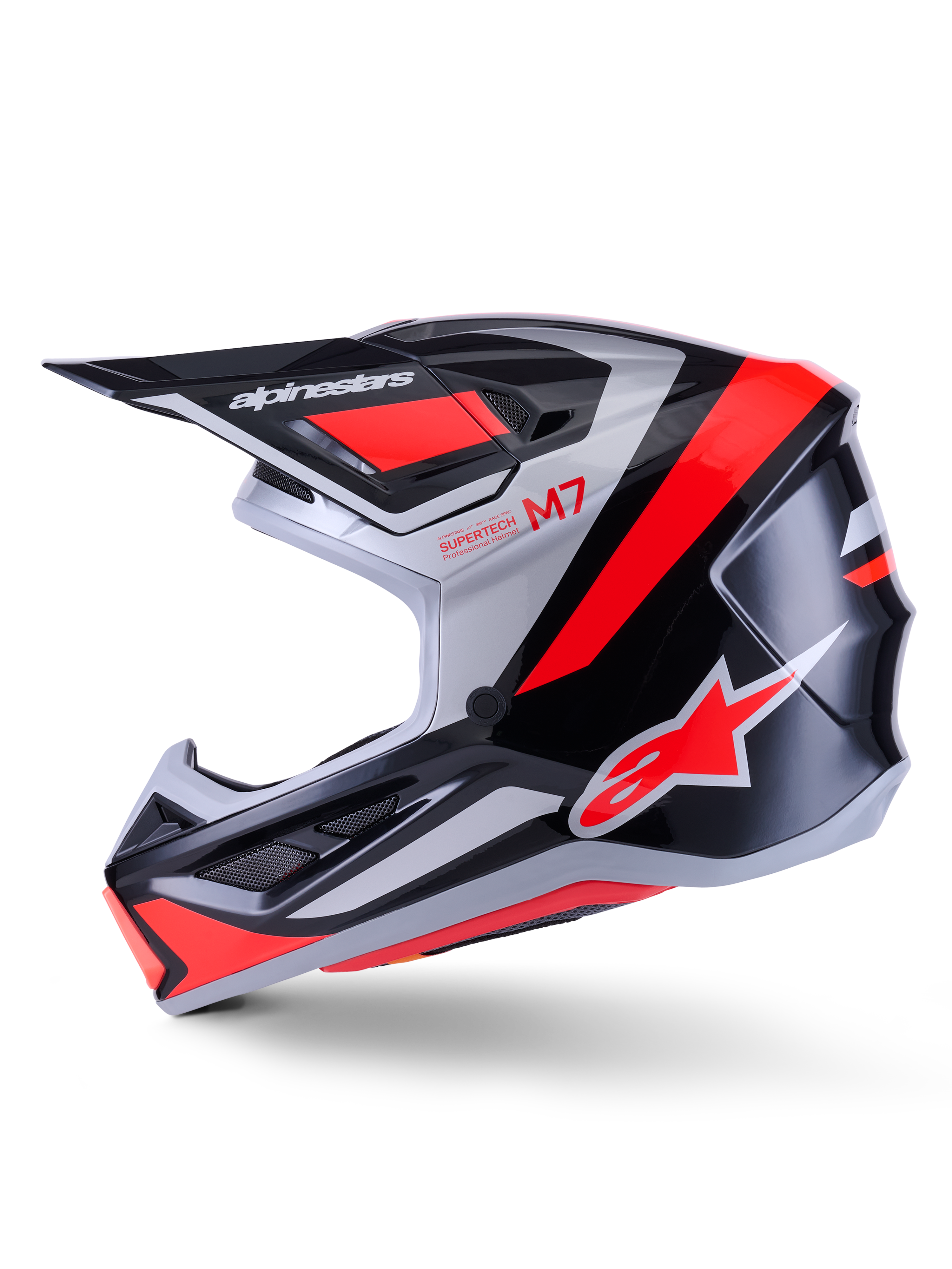 Casco Alpinestars S-M7 Rise, casco de motocross, negro, plata y rojo flúor brillante, vista de perfil lateral con calota aerodinámica de material compuesto, mentonera ventilada y visera prominente con la marca Alpinestars
