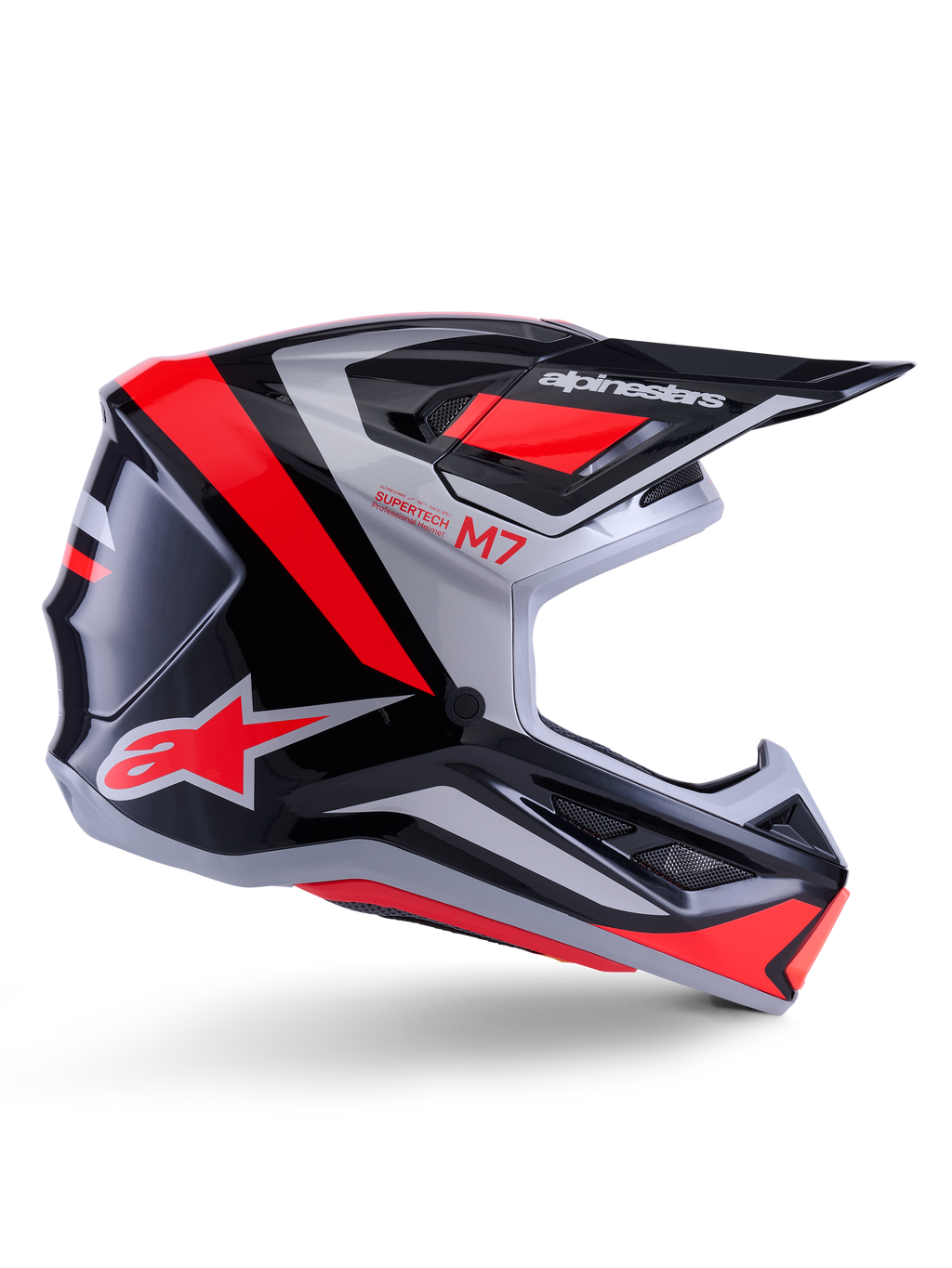 Casco Alpinestars S-M7 Rise, casco de motocross, negro, plateado y rojo flúor, vista lateral que muestra un diseño aerodinámico angular con visera y aberturas de ventilación, acabado brillante, serie Supertech M7