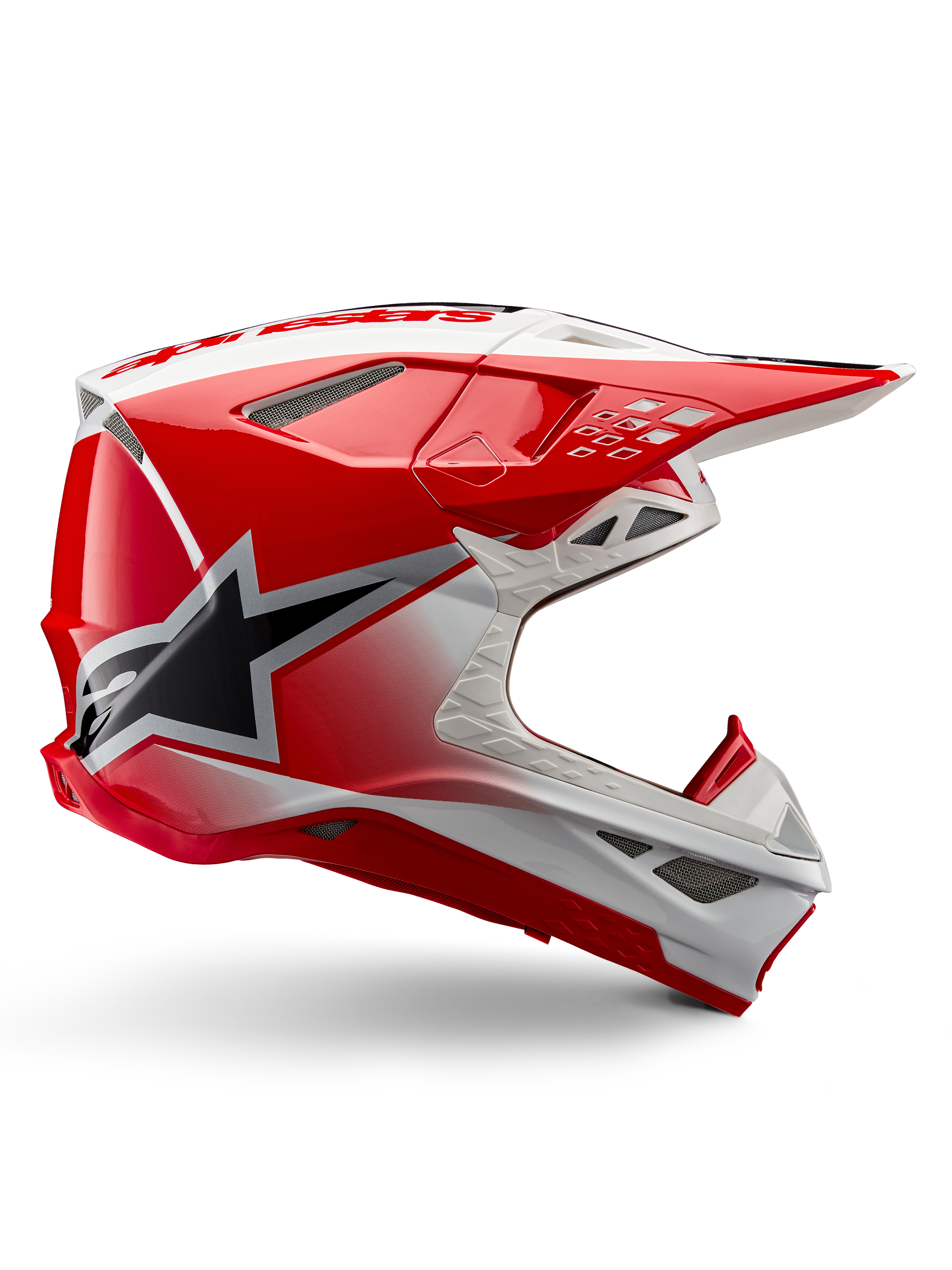 Alpinestars Supertech M10 Unite Helmet, casco de motocross, rojo y blanco brillante, vista lateral con patrones geométricos angulares, gráfico de estrella negra, múltiples rejillas de ventilación de malla y diseño aerodinámico para carreras todoterreno